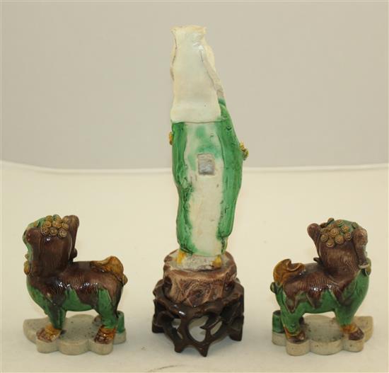 Three Chinese Sancai glazed biscuit figures, early 18th century, 10cm, one Buddhist lion restored, all with wood stands